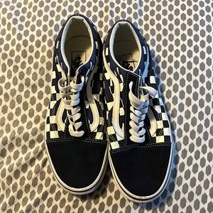 Unisex vans sneakers with black and white checker board design and blue flames.